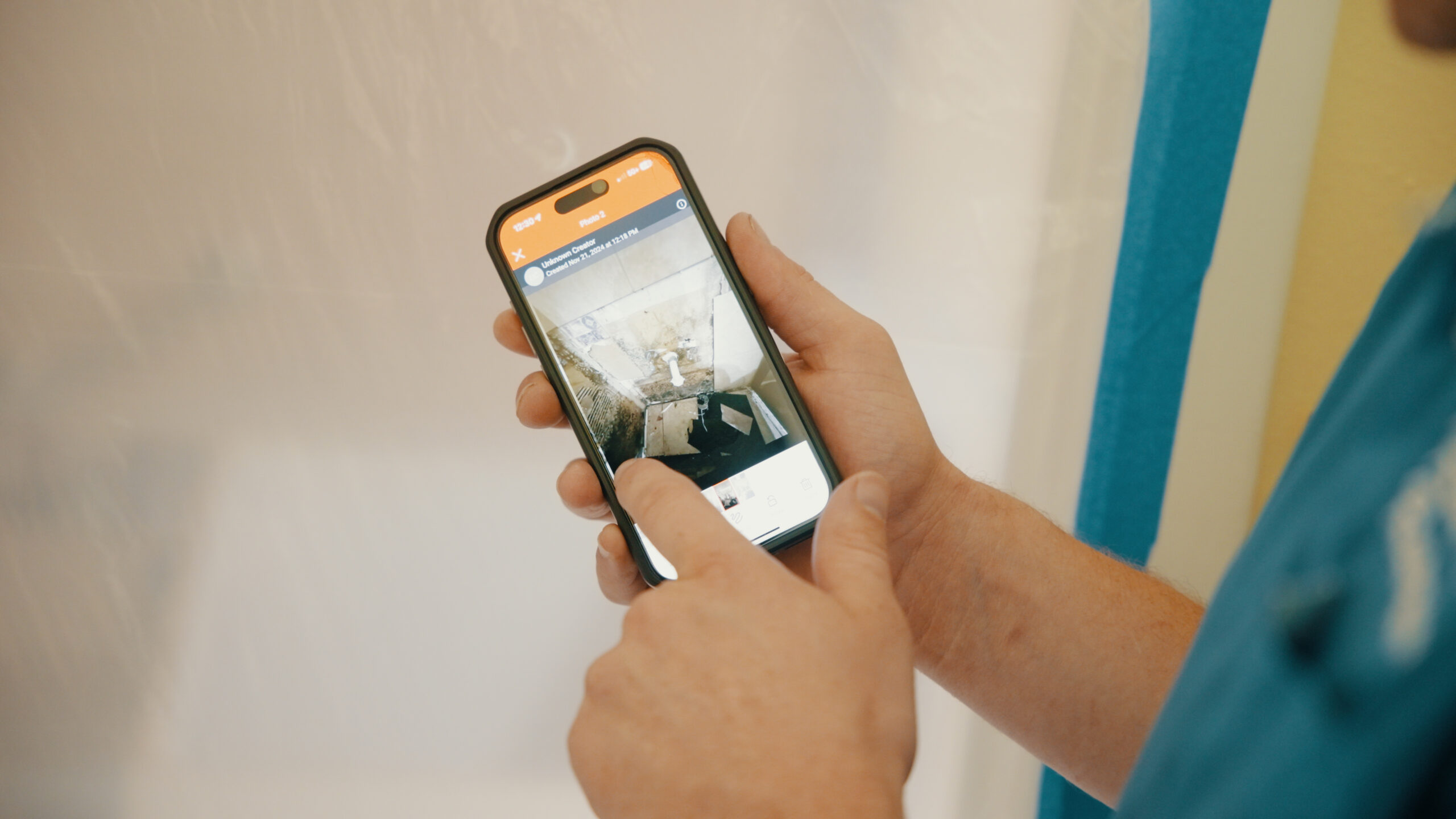 A man is holding a smartphone