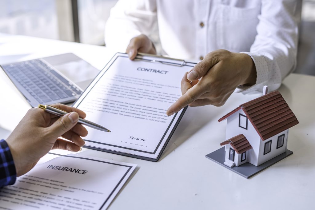 Estate agent broker reach contract form to client signing agreement contract real estate with approved mortgage application form, buying or concerning mortgage loan offer for and house insurance.